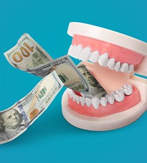 Artificial teeth chomping two $100 bills