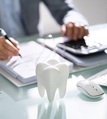 A patient calculating the cost of their dental emergency