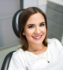 A beautiful and smiling woman sitting in a dentist’s chair