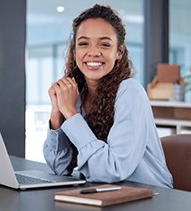 Woman smiling while working in office